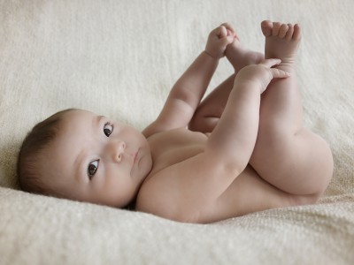 Baby Photography Liverpool - Baby laying on back holding both feet